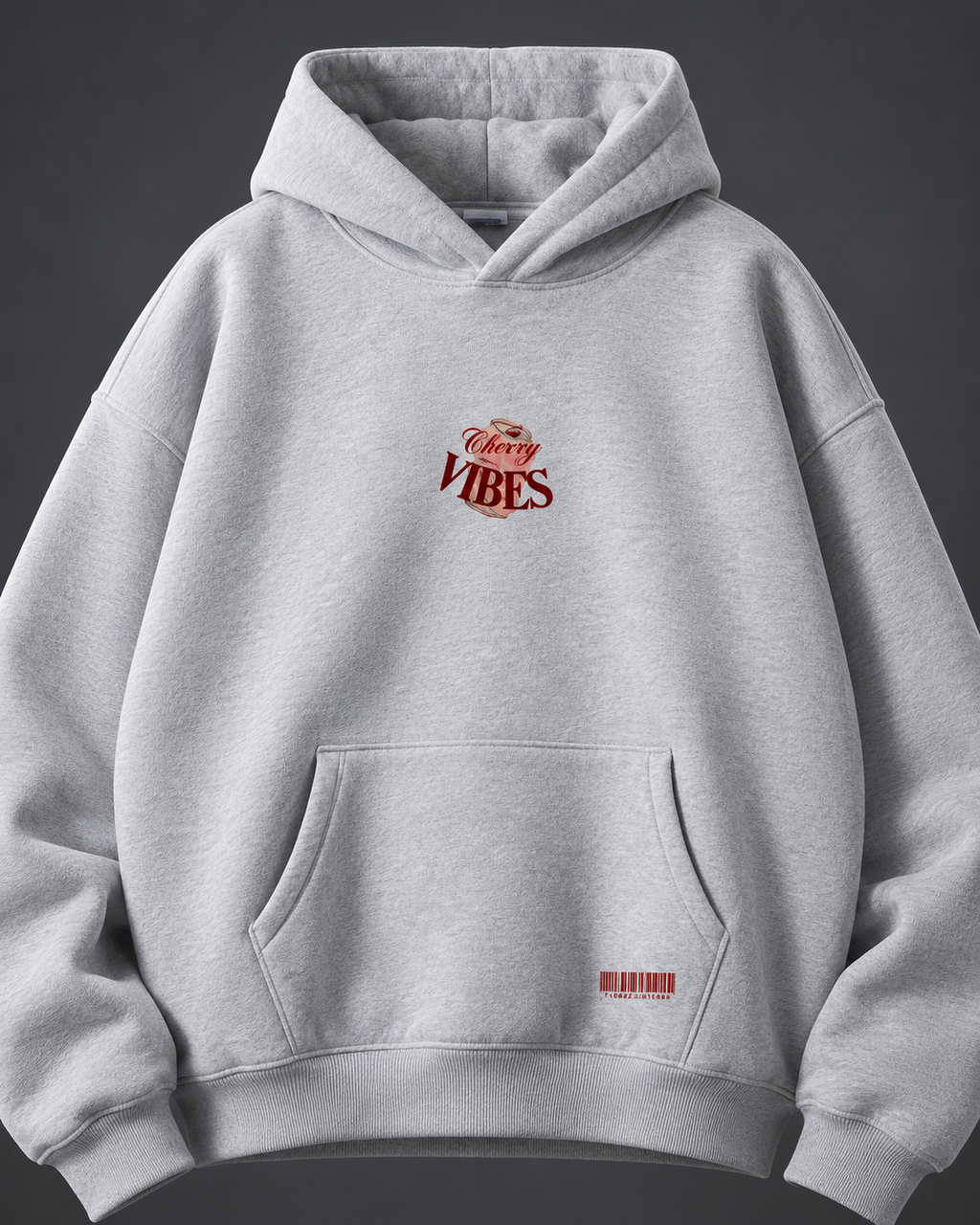 Cherry Vibes grey oversized hoodie — front detail on charcoal studio background