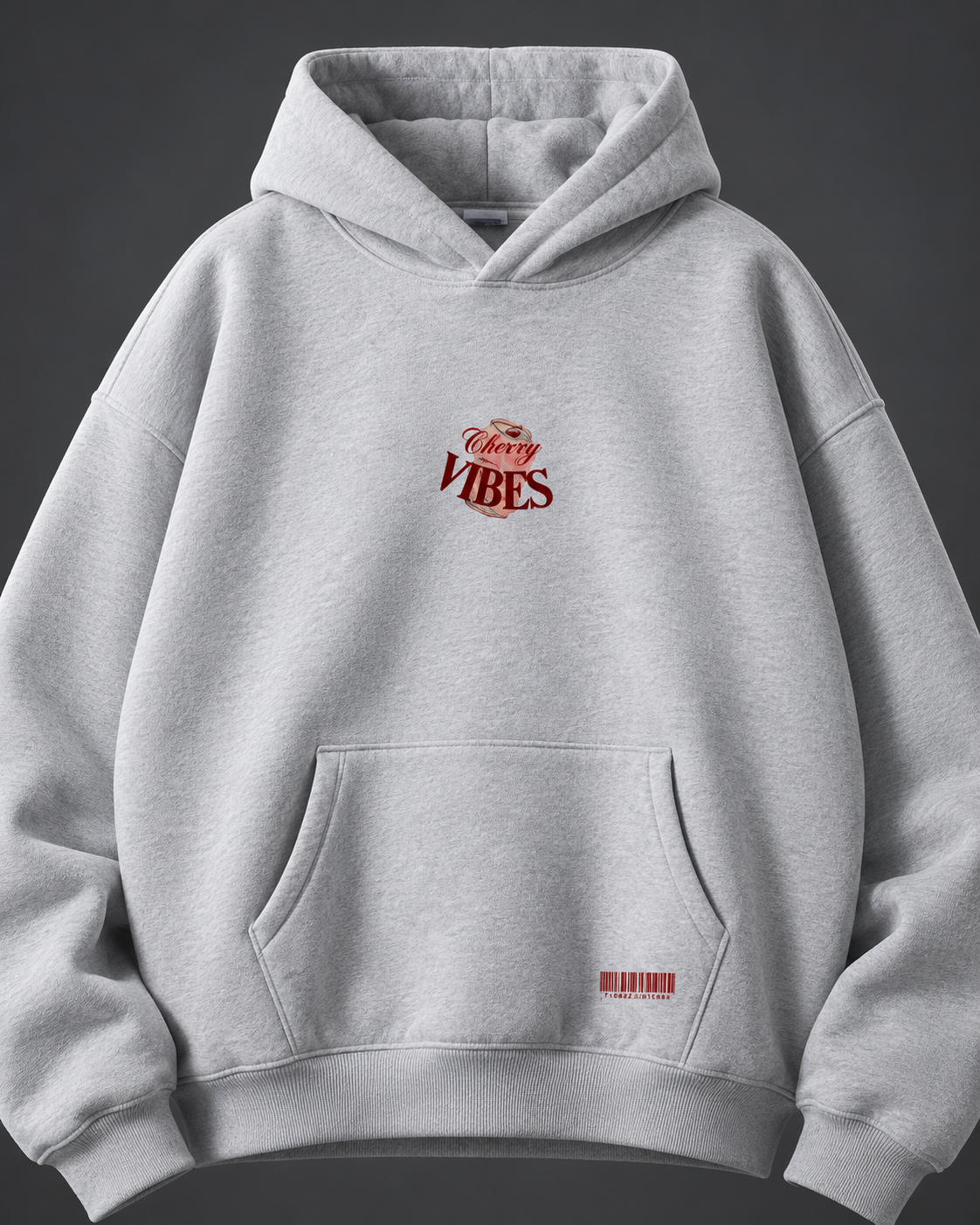 Cherry Vibes grey oversized hoodie — front detail on charcoal studio background