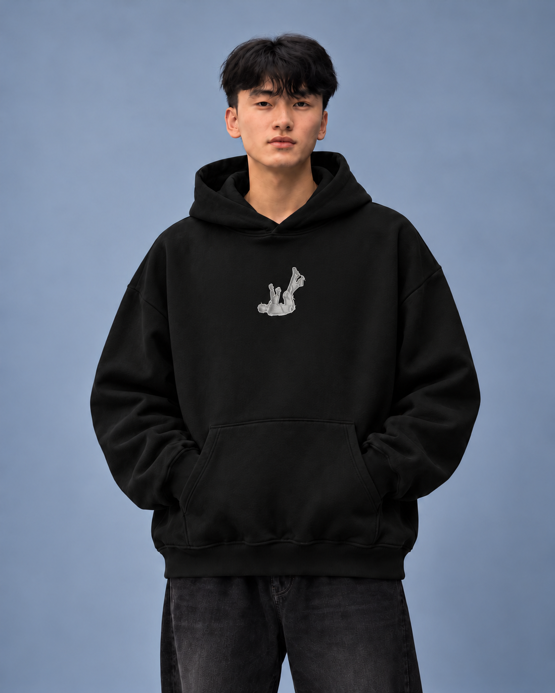 Fallen Desire black hoodie — model front on light grey studio background