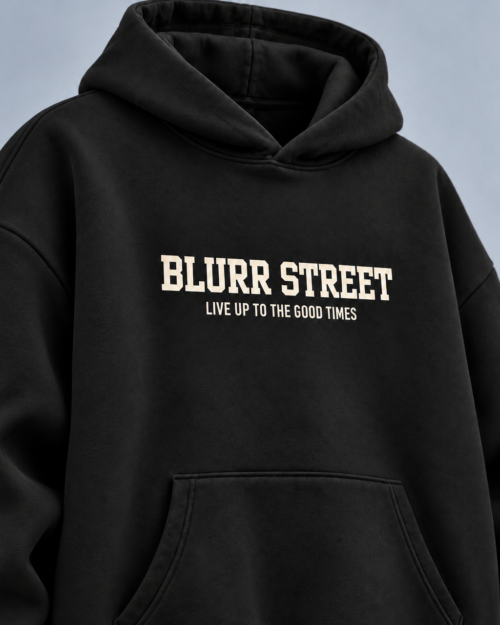 Street Soul black hoodie — front detail on light slate-grey studio background
