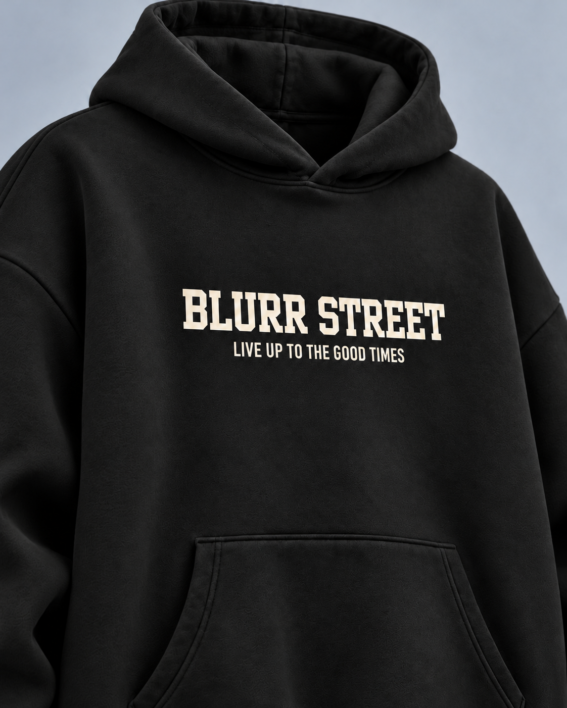 Street Soul black hoodie — front detail on light slate-grey studio background