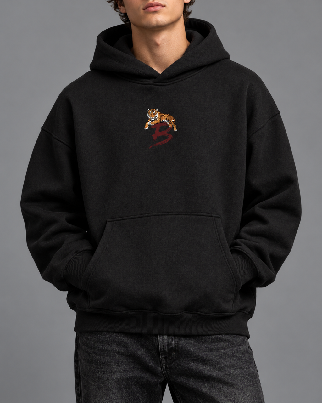 Tiger Crest oversized hoodie — black model studio photograph